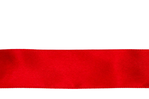 istock The red silk ribbon is evenly stretched on the white surface 894062112