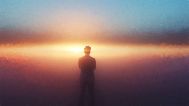 istock Pensive businessman looking into sunset 894069192