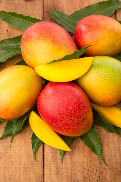 istock Mangoes on wooden table 894071654