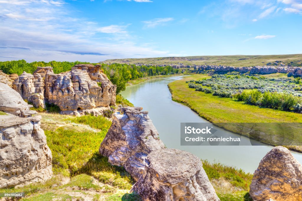 Hoodoo Badlands at Writing-on-Stone Provincial Park in Canada Unique Hoodoo rocks straddle the Milk River at Writing-on-Stone Provincial Park in Alberta, Canada. The area contains the largest concentration of First Nation petroglyphs (rock carvings) and pictographs (rock paintings) on the great plains of North America. Canada Stock Photo