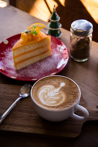 coffee aroma latte art cup and tasty christmas cake on wood table relaxtime in cafe coffee shop