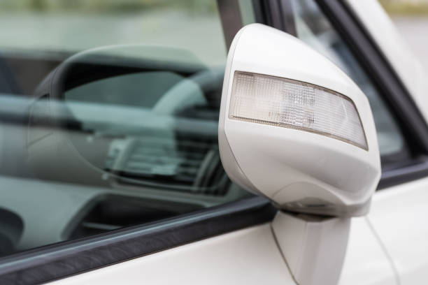 istock Side rear-view mirror closed for safety at car park 894108548