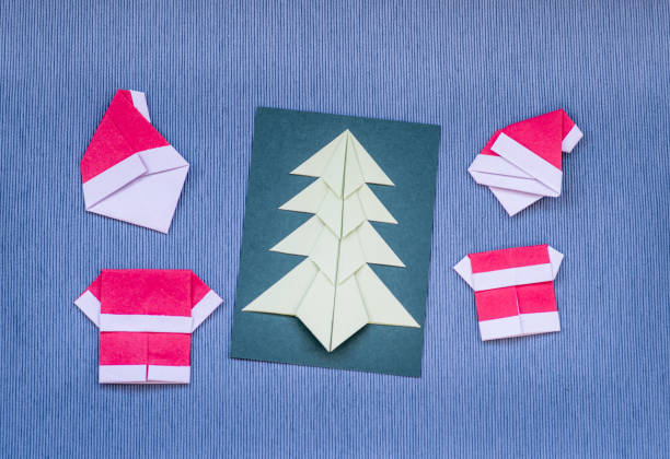 istock christmas origami craft on blue background 894119378