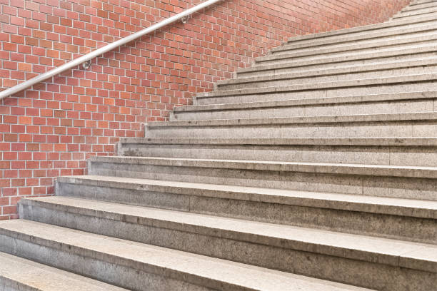 istock Concrete staircase and stone brick wall in subway station 894119650