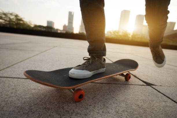 istock female skateboarder riding with skateboard on city 894132256