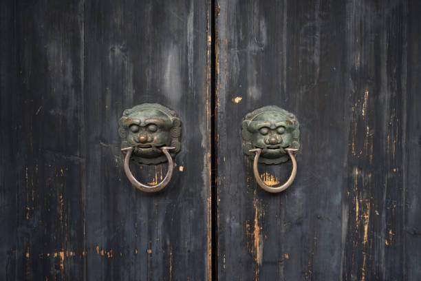 istock Bronze lions gate rings on wooden doors in ancient China 894150366