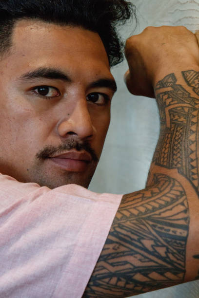 istock Samoan business man with tattoos on his arm 894162040