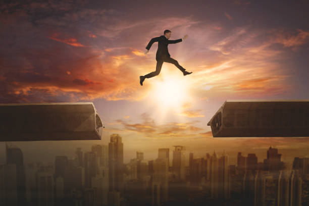 istock Male entrepreneur jumping gap on the bridge 894181478