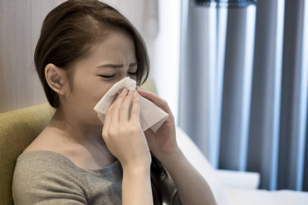 istock woman sick and sneezing 894183912