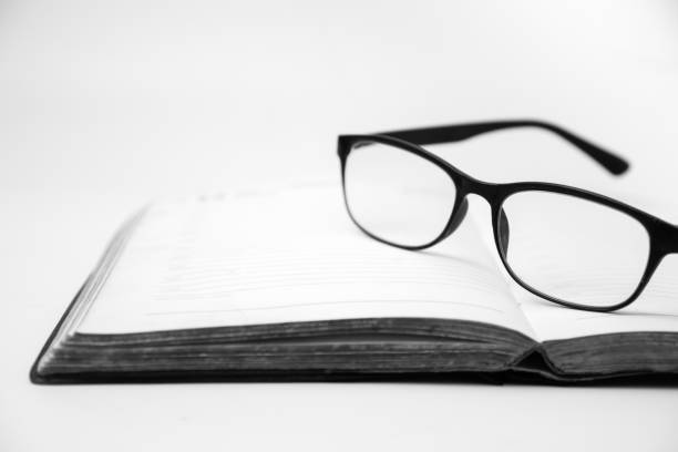 istock Eyeglasses on an open book, Black and White tone 894184074