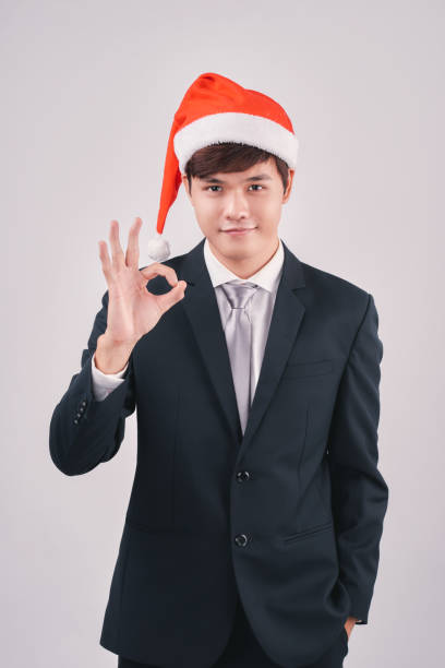 istock Asian businessman celebrating christmas isolated on white background 894184268