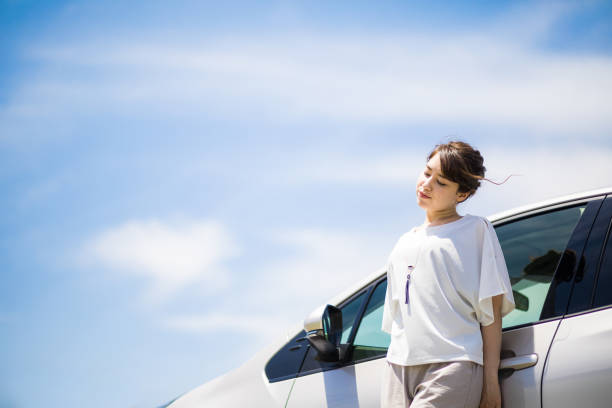 istock woman driver and vehicle under the blue sky. 894186744