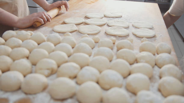 istock Cook roll the dough for baking, pieces of raw dough on the Board 894191682