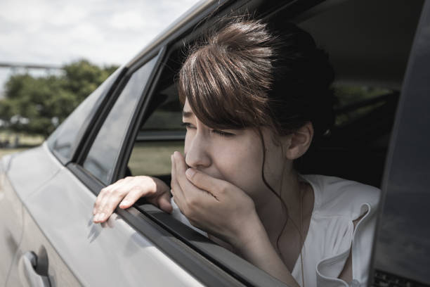 istock young woman getting carsickness. 894194520
