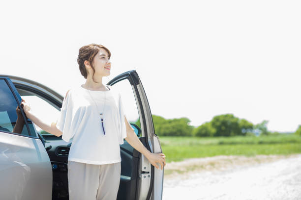 istock woman getting out of a car. 894201714