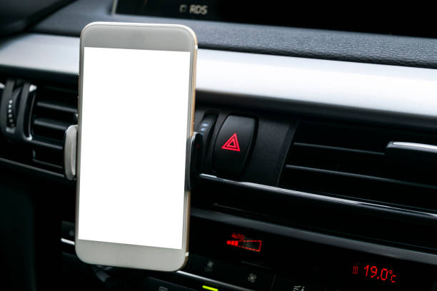 istock Smartphone in a car use for Navigate or GPS. Driving a car with Smartphone in holder. Mobile phone with isolatede white screen. Blank empty screen. copy space. Empty space for text. car interior 894203700