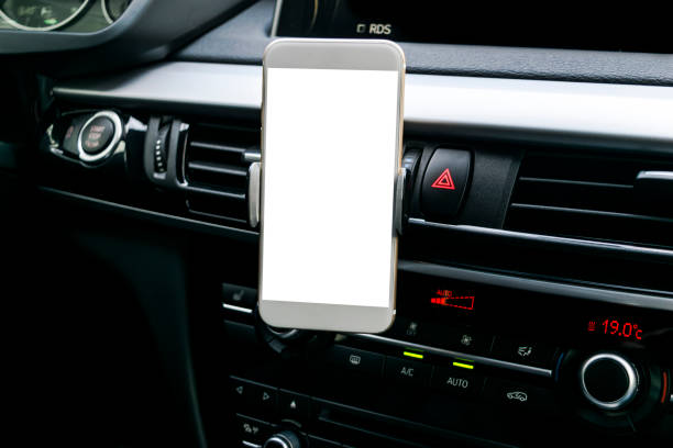 istock Smartphone in a car use for Navigate or GPS. Driving a car with Smartphone in holder. Mobile phone with isolatede white screen. Blank empty screen. copy space. Empty space for text. modern car interior details. 894203742