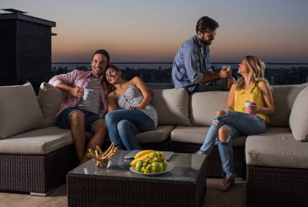 istock Young happy couples enjoying their time on a penthouse patio. 894206236