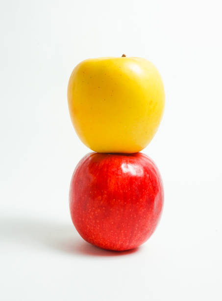 istock red apple and yellow apple, white background 894211570