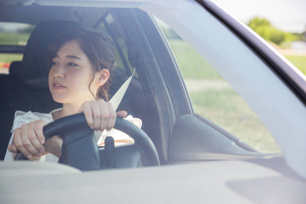 istock young woman driving a car. 894224364