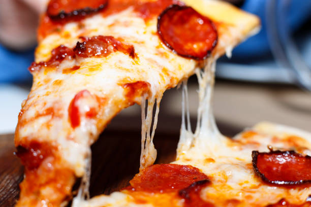 Closeup of a piece of pepperoni pizza. Italian pizza. stock photo