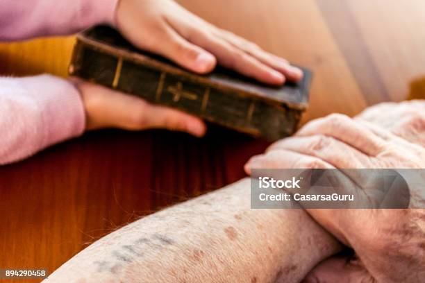 Close Up Hands Of Great Grandmother Showing Old Holy Bible Stock Photo - Download Image Now