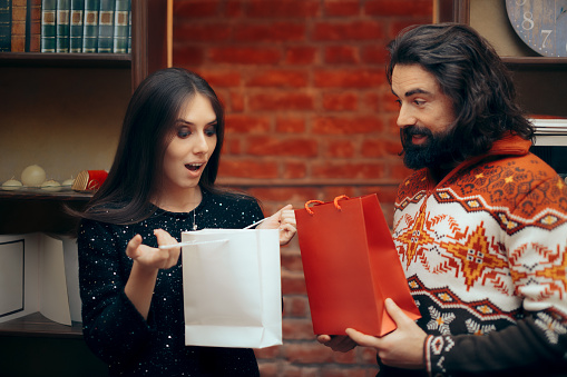 Girlfriend giving and receiving a gift celebrating the relationship anniversary