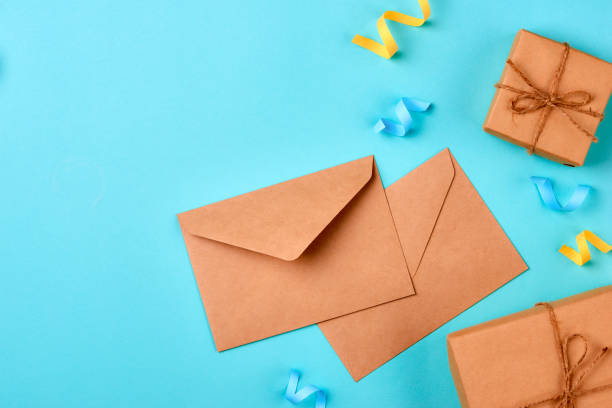 istock Celebration envelope, birthday party things and laptop on a yellow background 894295994