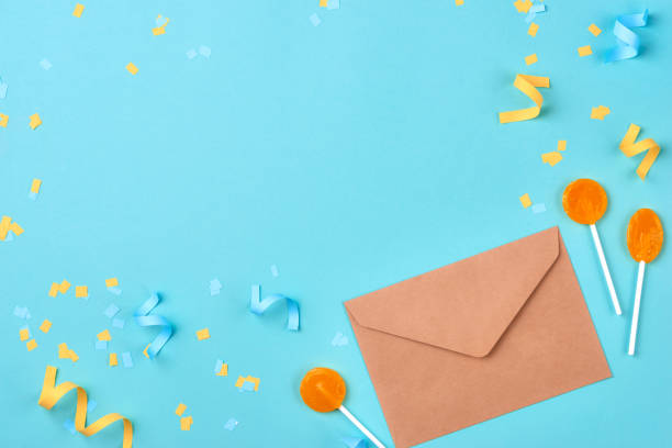 istock Celebration envelope, birthday party things and laptop on a yellow background 894296328