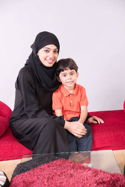 istock Arab muslim mother with her child at home 894308704