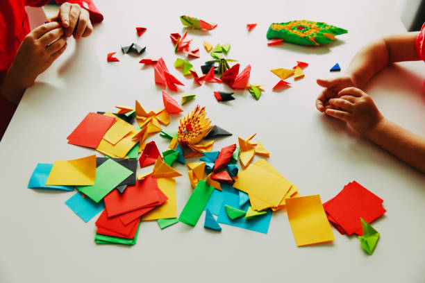 istock kids making origami crafts with paper 894311652