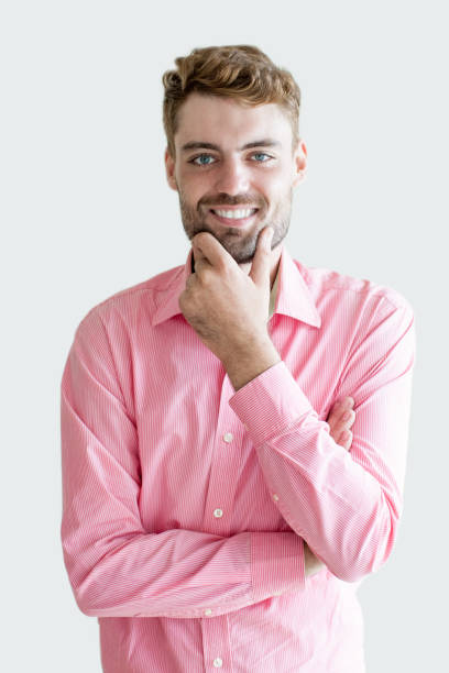 istock Smiling Young Handsome Man Touching Chin 894315604