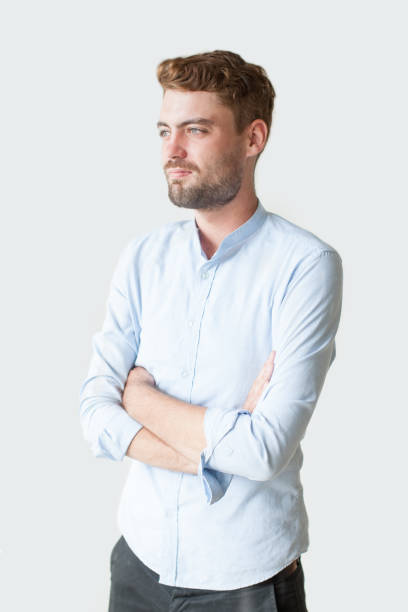 istock Portrait of Thoughtful Young Man Folding Arms 894315648