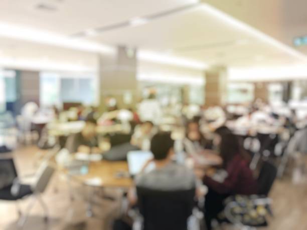istock blurred image of university students training / reading / searching for books / and preparing for the final examination in modern library at university, blur group of people or researcher 894318314