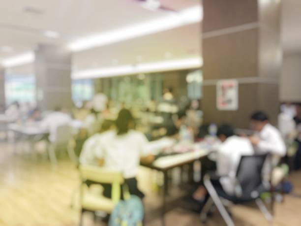 istock blurred image of university students training / reading / searching for books / and preparing for the final examination in modern library at university, blur group of people or researcher 894318470