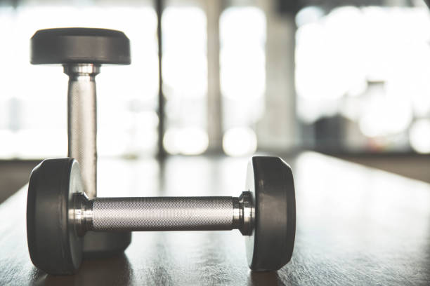 istock Dumbbells on Wooden table in Gym 894318606