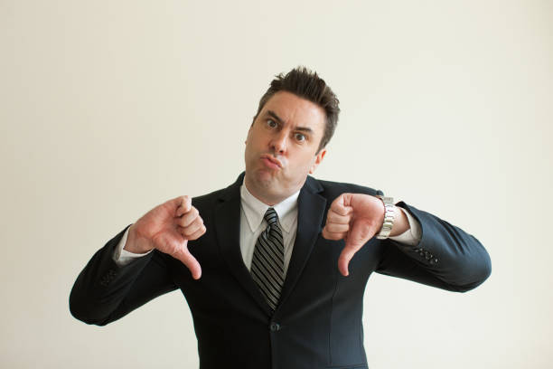 istock Displeased businessman showing thumbs down 894322470