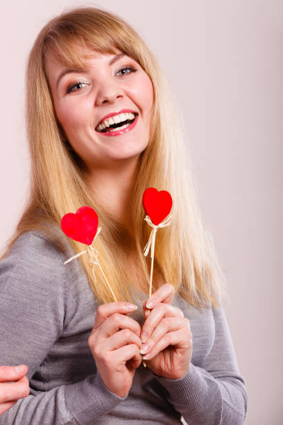 istock Cheerful girl fooling with hearts. 894324748
