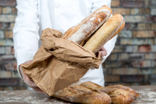 istock a baker holding traditional bread french baguettes 894324866