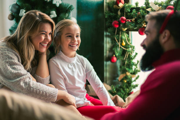 istock Family celebrating Christmas at home. 894330648