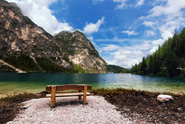 istock Bench near mountain lake 894331328