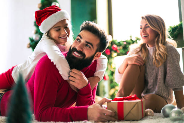 istock Family celebrating Christmas at home. 894331336