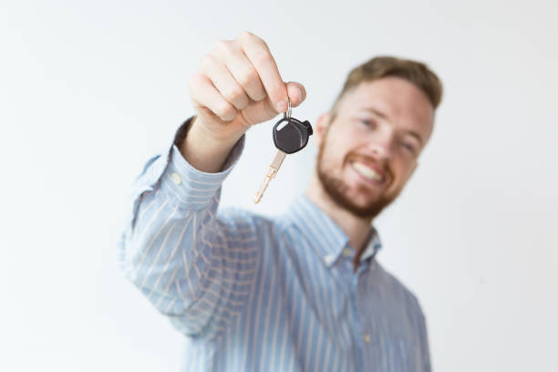 istock Content Young Man Holding Key to New Car 894333494