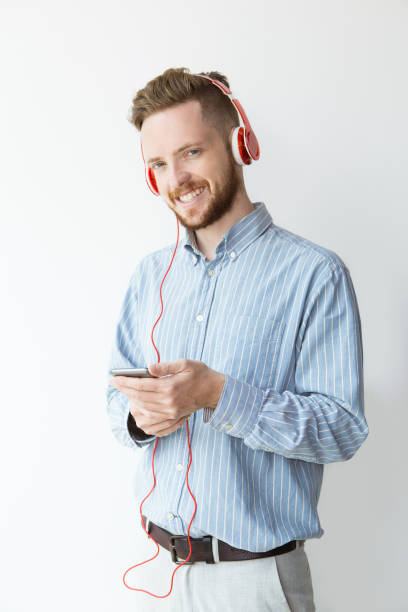 istock Happy Young Man in Headphone Holding Smartphone 894333504