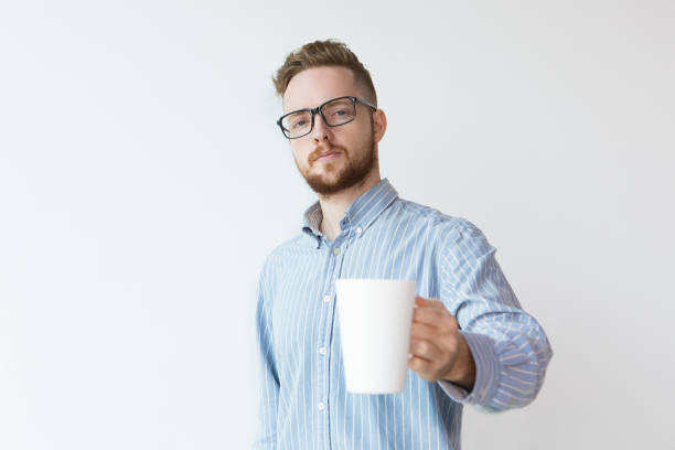 istock Serious Young Man with White Cup and Toast Gesture 894333618
