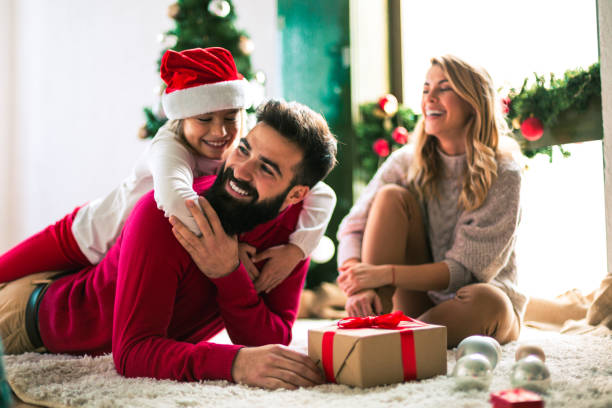istock Family celebrating Christmas at home. 894333928