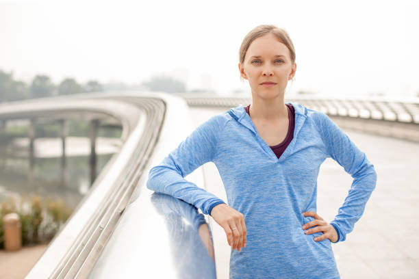istock Serious Sporty Attractive Woman on Bridge 894337058