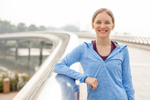 istock Smiling Sporty Attractive Woman on Bridge 894337078