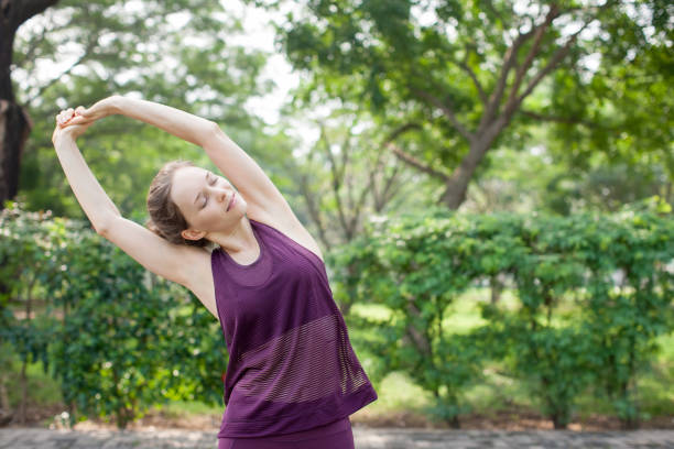 istock Sporty Woman Doing Side Bend Exercise in Park 894337142