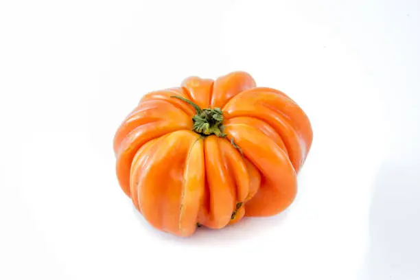 Photo of Cuore di Bue (oxheart or beeftake) tomato isolated on a white background